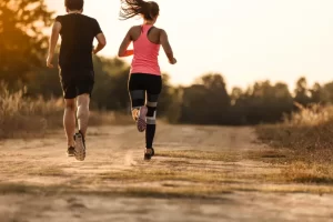 young-couple-running-forest-trail-845x563